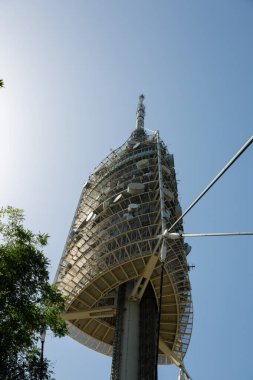 Torre de collserola telecommunications tower is standing tall over the city of barcelona, spain clipart