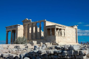 Süvariler, kadın örtülü figürler, erekteyonun destekleyici sütunları olarak hizmet veriyorlar, Atina akropolünün kuzey tarafında antik bir Yunan tapınağı.