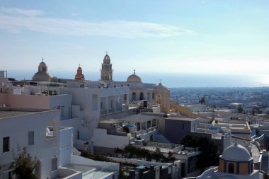 Geleneksel beyazlatılmış kilise ve kayalıklara tünemiş evler Santorini, Yunanistan 'daki Ege Denizi manzaralı bir manzara yaratır.