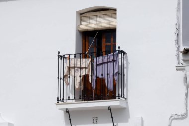Aracena, Huelva, Endülüs, İspanya 'daki beyaz binalar arasında yokuş yukarı giden dar bir kaldırım taşı caddesi.