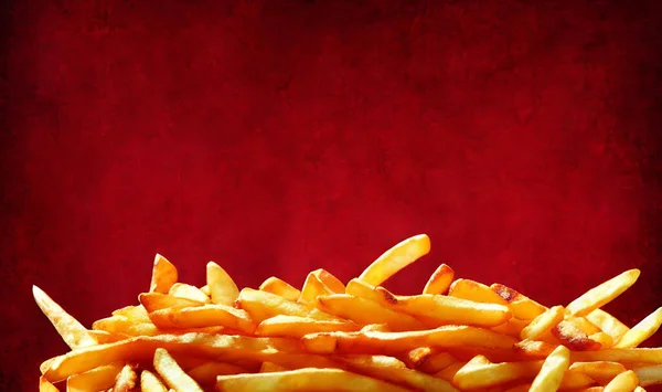 Delicious hot and crispy fried potatoes. Fast food and restaurant products. Yummy golden french fries as background.