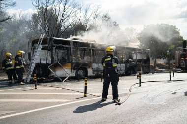 Portugal, Odivelas 07 September 2022 Rescue Team of Firefighters Arrive on the Car Crash fired passenger bus Traffic Accident Scene. Firemen fire department fight with fire on road. Accident disaster
