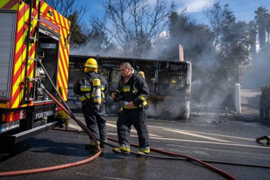 Portugal, Odivelas 07 September 2022 Rescue Team of Firefighters Arrive on the Car Crash fired passenger bus Traffic Accident Scene. Firemen fire department fight with fire on road. Accident disaster