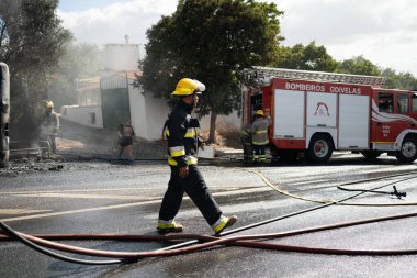 Portugal, Odivelas 07 September 2022 Rescue Team of Firefighters Arrive on the Car Crash fired passenger bus Traffic Accident Scene. Firemen fire department fight with fire on road. Accident disaster