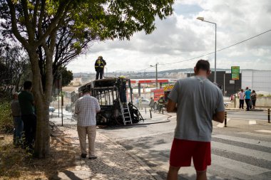 Portugal, Odivelas 07 September 2022 Rescue Team of Firefighters Arrive on the Car Crash fired passenger bus Traffic Accident Scene. Firemen fire department fight with fire on road. Accident disaster