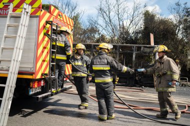 Portugal, Odivelas 07 September 2022 Rescue Team of Firefighters Arrive on the Car Crash fired passenger bus Traffic Accident Scene. Firemen fire department fight with fire on road. Accident disaster