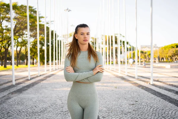 Girl athlete, summer city. Resting after playing sports on street. In  leggings and swimsuit. Woman with tattoos. He looks into the distance,  covers Stock Photo - Alamy