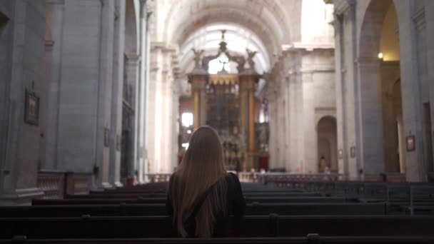 Woman Long Blonde Hair Prays While Sitting Bench Church Rear — Stockvideo