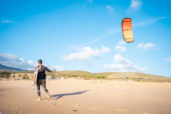 Portrait Wave Kitesurfer Walking Upwind Beach His Board Kite Man — Stock Photo, Image