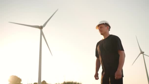 Engineer Man White Hard Hat Walking Field Huge Windmills Summer — Stock videók