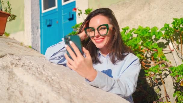 Woman Glasses Using Smartphone Sitting Outdoor Looking Device Screen Smile — 图库视频影像