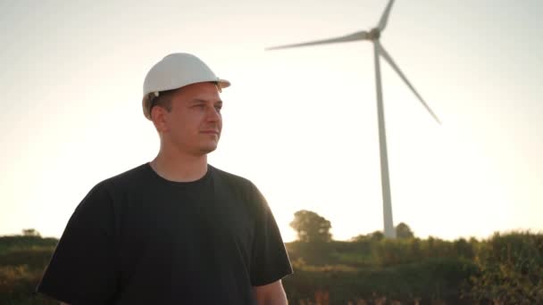 Engineer Man White Hard Hat Walking Field Huge Windmills Summer — Video
