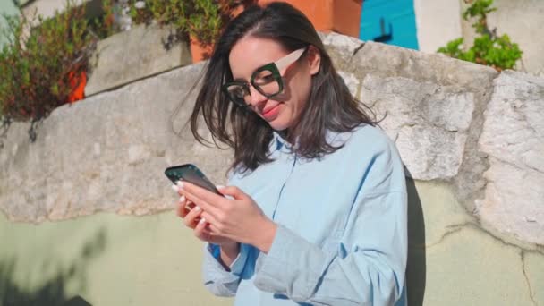 Woman Glasses Using Smartphone Standing Outdoor Looking Device Screen Smile — 图库视频影像