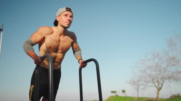 Muscular Man Doing Push Ups Exercises Parallel Bars Male Athlete — стоковое видео
