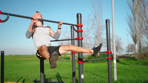 Athletic Man Does Pull Ups Exercises Raised Legs Horizontal Bar — стоковое видео