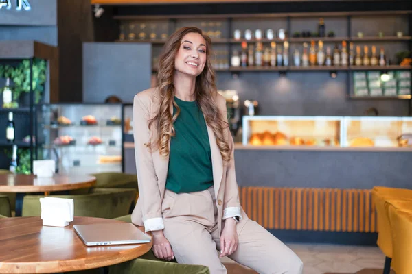 Business Woman Restaurant Owner With Laptop In Hands Dressed Elegant Pantsuit Sitting On Table In Restaurant With Bar Counter Background Caucasian Female Business Person Indoor