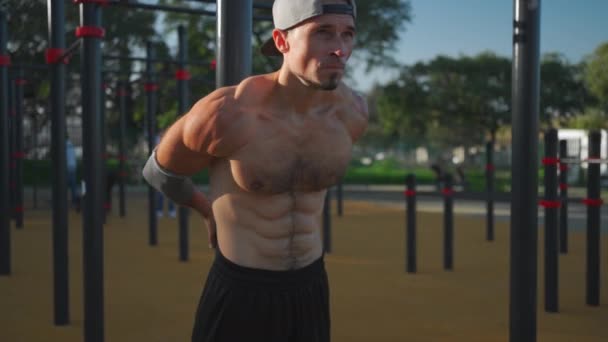 Athletic Man Stretching Body Holding Crossbar Modern Calisthenics Park Outdoors — Stock Video