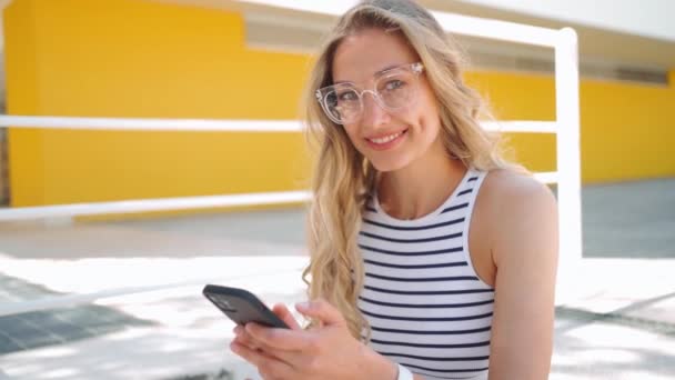 Νεαρή Όμορφη Ξανθιά Λευκή Γυναίκα Που Φοράει Γυαλιά Κάθεται Στην — Αρχείο Βίντεο