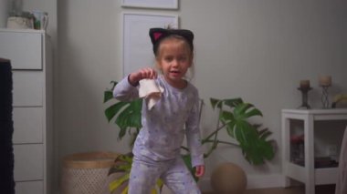 Crazy child dancing at home funny moving Going Mad and Emotional Little Girl. Young Funny Girl Yelling Screaming. Child Scream Loudly. Attention Deficit Hyperactivity Disorder.