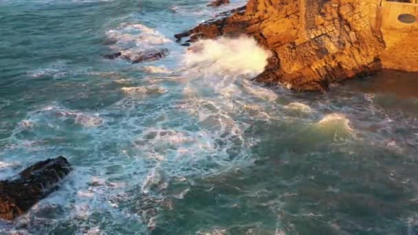 ポルトガルの空中ドローンビューリスボンの大西洋岸 日の出 シントラ プライア アドラガビーチで岩に衝突し 破壊する波を持つ劇的な頑丈なロッキー海岸線 — ストック動画