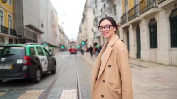 Attractive Young Woman Beige Coat Crossing Street Holding Her Smartphone — стоковое видео