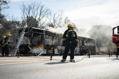 Portugal, Odivelas 07 September 2022 Rescue Team of Firefighters Arrive on the Car Crash fired passenger bus Traffic Accident Scene. Firemen fire department fight with fire on road. Accident disaster