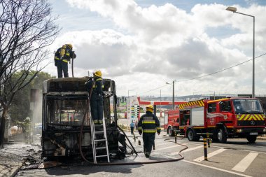 Portugal, Odivelas 07 September 2022 Rescue Team of Firefighters Arrive on the Car Crash fired passenger bus Traffic Accident Scene. Firemen fire department fight with fire on road. Accident disaster