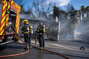 Portugal, Odivelas 07 September 2022 Rescue Team of Firefighters Arrive on the Car Crash fired passenger bus Traffic Accident Scene. Firemen fire department fight with fire on road. Accident disaster