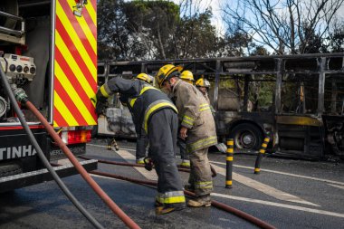 Portugal, Odivelas 07 September 2022 Rescue Team of Firefighters Arrive on the Car Crash fired passenger bus Traffic Accident Scene. Firemen fire department fight with fire on road. Accident disaster
