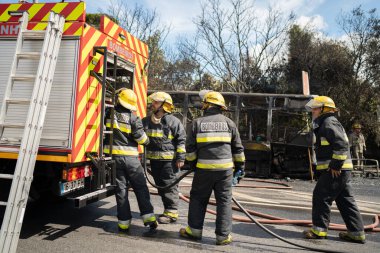 Portugal, Odivelas 07 September 2022 Rescue Team of Firefighters Arrive on the Car Crash fired passenger bus Traffic Accident Scene. Firemen fire department fight with fire on road. Accident disaster