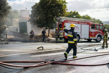 Portugal, Odivelas 07 September 2022 Rescue Team of Firefighters Arrive on the Car Crash fired passenger bus Traffic Accident Scene. Firemen fire department fight with fire on road. Accident disaster