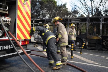 Portugal, Odivelas 07 September 2022 Rescue Team of Firefighters Arrive on the Car Crash fired passenger bus Traffic Accident Scene. Firemen fire department fight with fire on road. Accident disaster