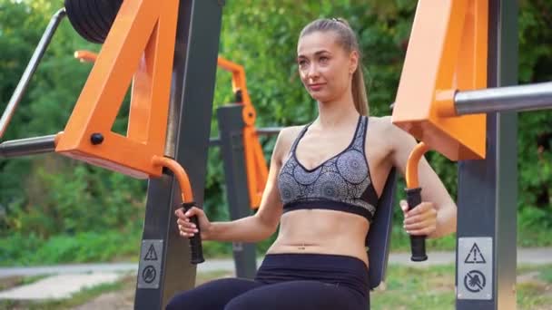 Uśmiechnięta Młoda Kobieta Odzieży Sportowej Ćwicząca Symulatorze Parku Siłowni Świeżym — Wideo stockowe