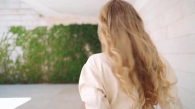 Moda gözlüklü, açık havada yürüyen mutlu, genç ve şık bir kadın. 30 'lu yaşlarda gülümseyen güzel bir kadın kameraya bakıyor.