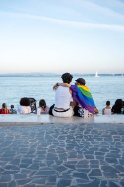 Gurur Yürüyüşü sırasında gezinti güvertesinde öpüşen romantik eşcinsel çift. Erkek arkadaşını öpen eşcinsel bir adam okyanus ve yelkenli geçmişi. Aşk ve lgbtqia kavramı. Havada aşk kokusu var