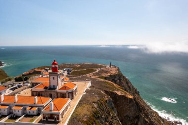 Cabo da Roca Deniz feneri ve anıtının büyüleyici hava manzarası dramatik uçurumları, okyanusu ve turistlerin ünlü manzarasını gözler önüne seriyor.