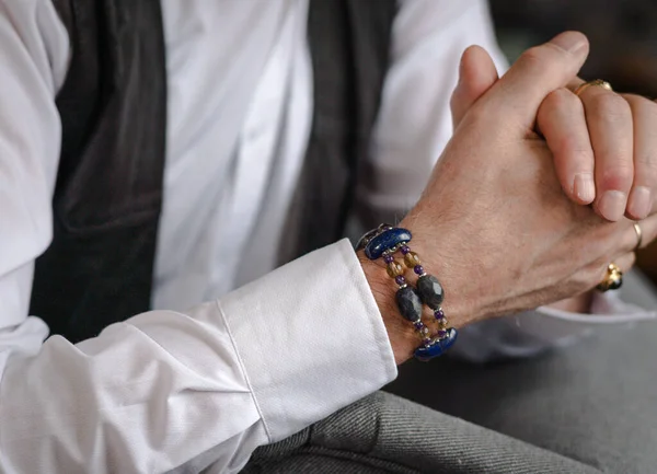 stock image A man's bracelet made of natural stones can be seen on the hand, close-up