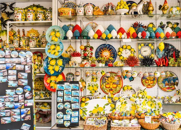 Ravello, İtalya - 27 Nisan 2025: Genellikle limon temalı küçük bir mağazanın raflarında çeşitli renkli hediyelik eşyalar. Amalfi Sahili, Ravello Kasabası.