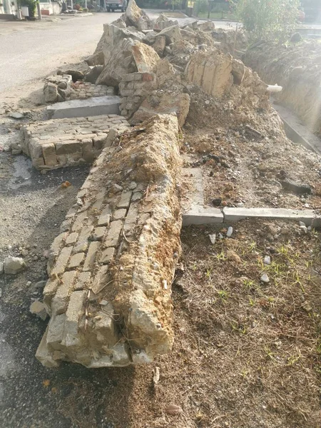 pile of broken concrete slab by the roadside