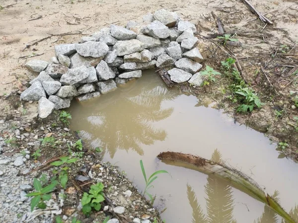 scene of the rain water flooded the farm concrete cylindrical drain