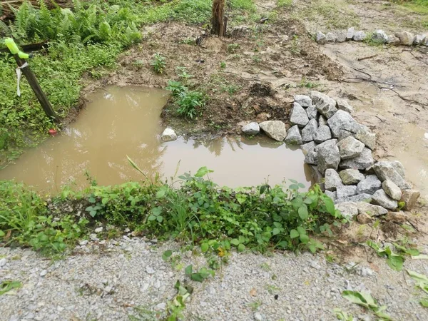 雨水が農場のコンクリートの円筒形の排水を氾濫させ — ストック写真