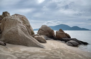 Sahilin yanında kocaman kayalar vardı.