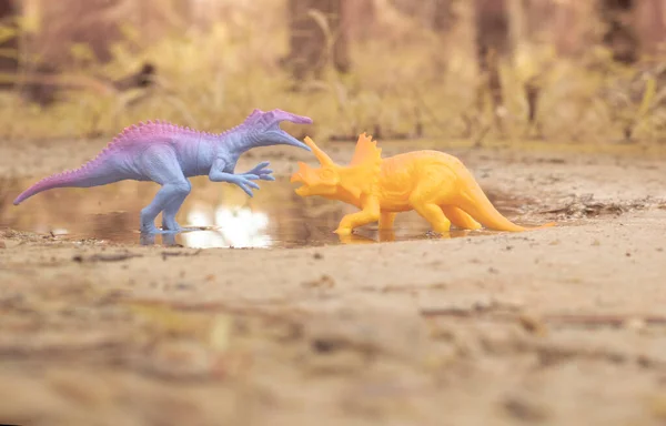 dinosaur toys illustrating loitering around the lake