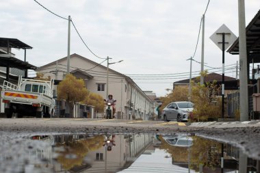 stagnant pool of water scene after rain at the suburb asphalt street 