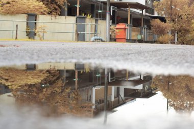 stagnant pool of water scene after rain at the suburb asphalt street 