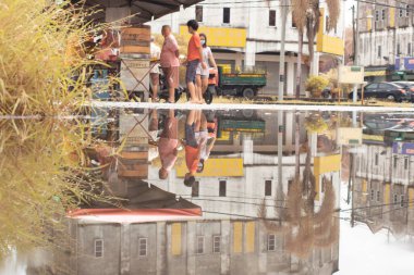 Perak,Malaysia. December 30,2022: Scene of the stagnant pool of water after rain around the suburb asphalt street at Kg Koh Market Area. 