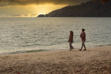 Perak, Malaysia. December 31,2022: Infrared image of leisure activity of people during cooling evening along the beach at Teluk Senangin.   