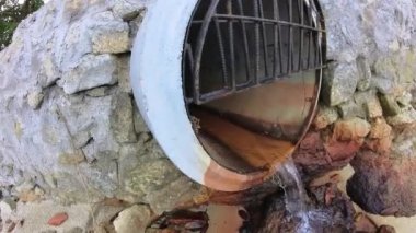 aerial scene of the vacant agriculture land fulls of puddle with man flying his drone.