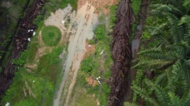 aerial scene of the vacant agriculture land fulls of puddle with man flying his drone.