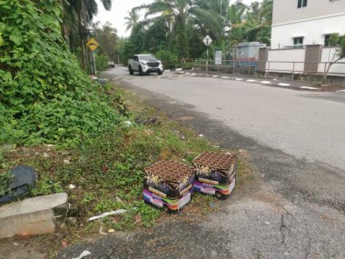Perak,Malaysia. January 25,2023: Used and thrown away two boxes of 36 shots ammo firework found along the roadside at Taman  Mas 1 street,Kg Koh.